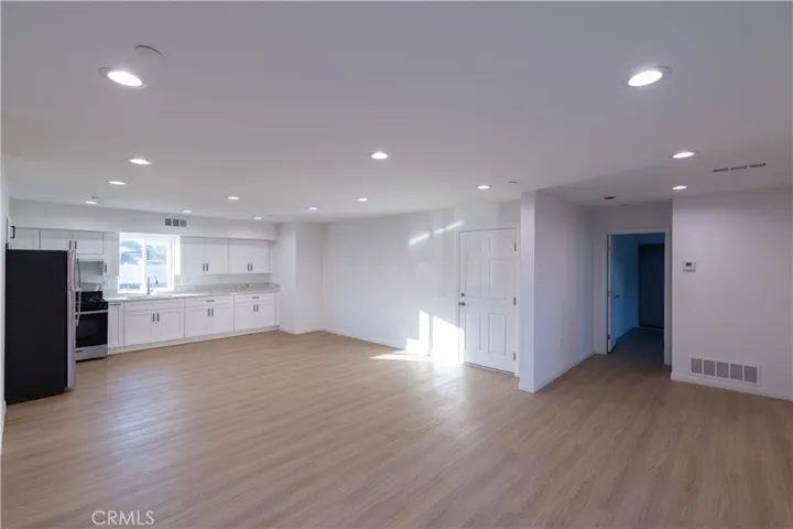 View of kitchen area that is open to living. Convenient direct access to the garage through door on the left.