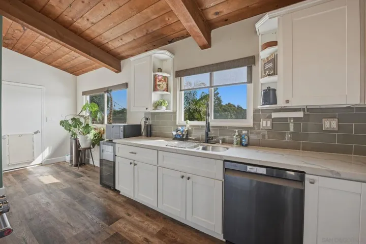 Kitchen has views of the large lot, entertaining spaces and pool