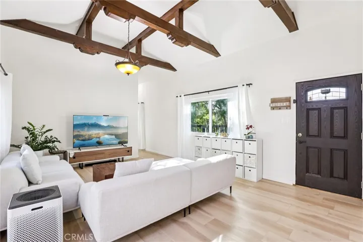 Open family room with beautiful wood beams