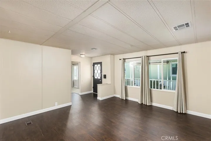 Family room with hard surface flooring.  Front door​​‌​​​​‌​​‌‌​​‌​​​‌‌​​​‌​​‌‌​​‌‌​​‌‌​​​​ entry.