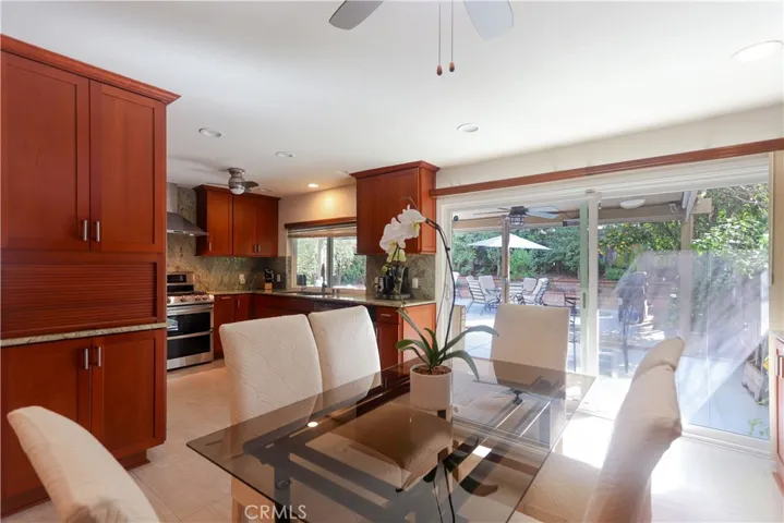 Open concept dining area with seamless flow to the kitchen and backyard patio.