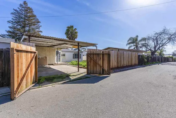 View of parking featuring a gate