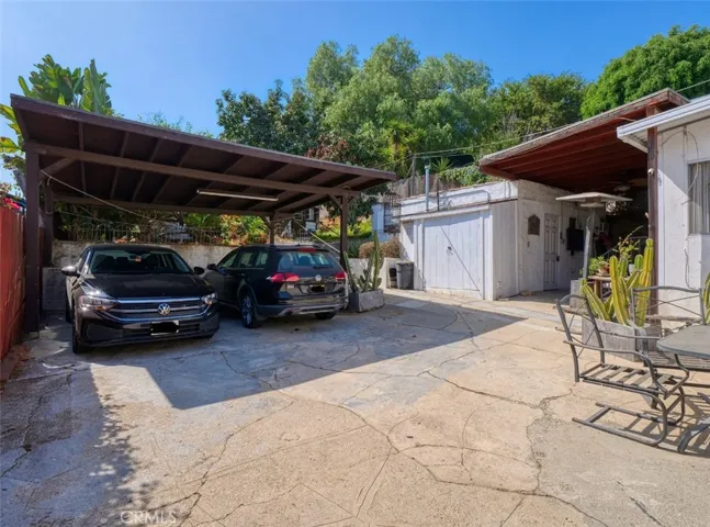 carport and storage structure to the right