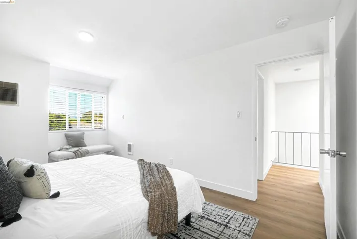 Bedroom with wood finished floors and baseboards
