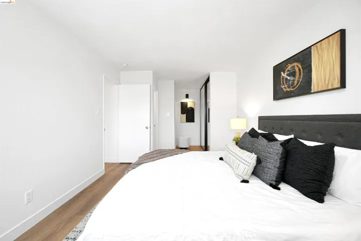 Bedroom featuring wood finished floors and ensuite bathroom