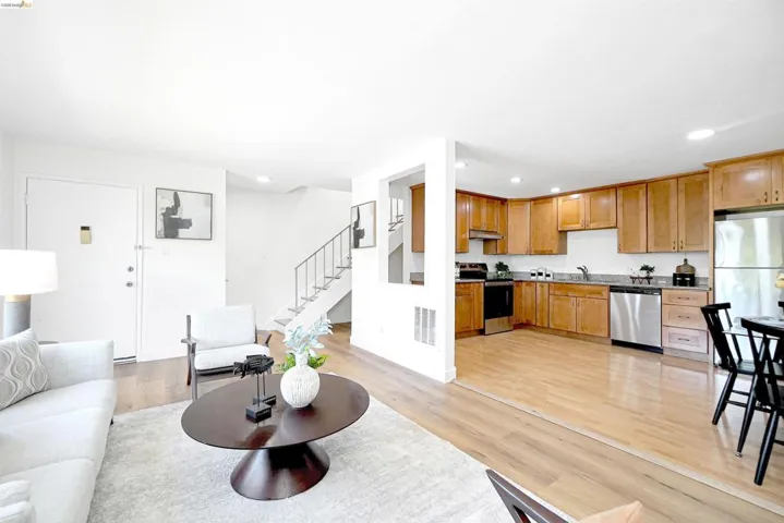 Living area with light wood-style flooring and recessed lighting