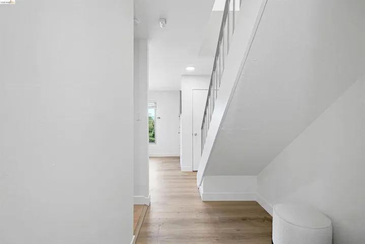 Corridor with light wood finished floors and recessed lighting
