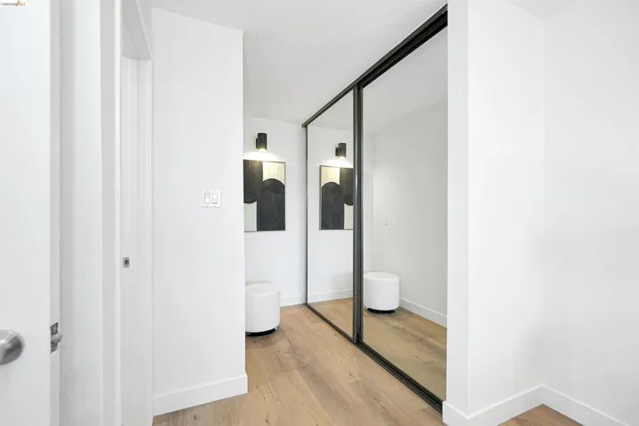 Hall with light wood-style flooring and baseboards