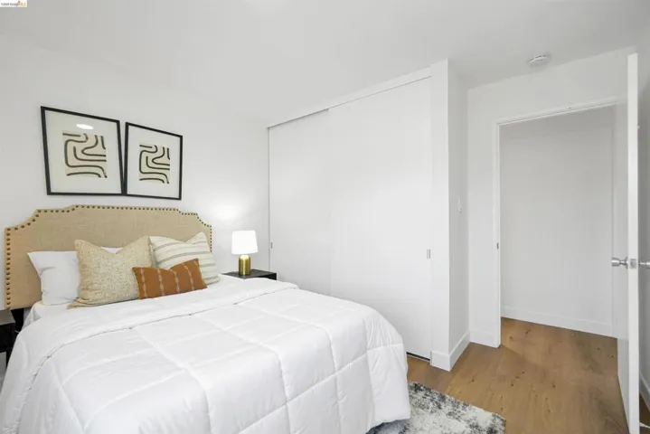 Bedroom with wood finished floors and a closet