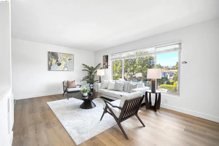 Living area with light wood-type flooring and baseboards
