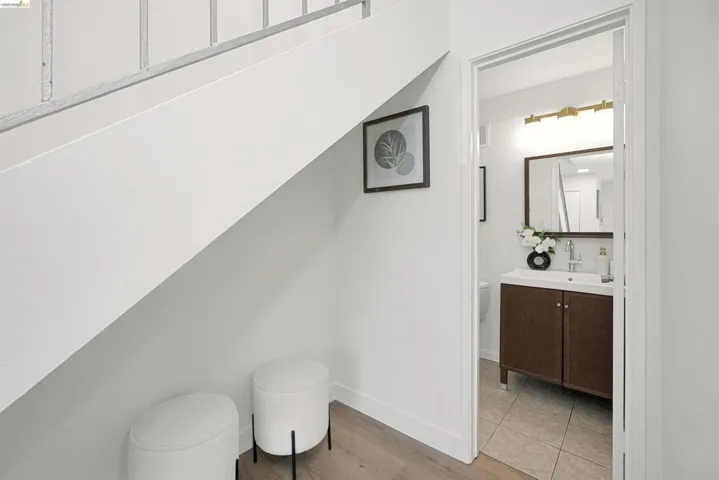 Half bathroom featuring vanity and light wood-style floors
