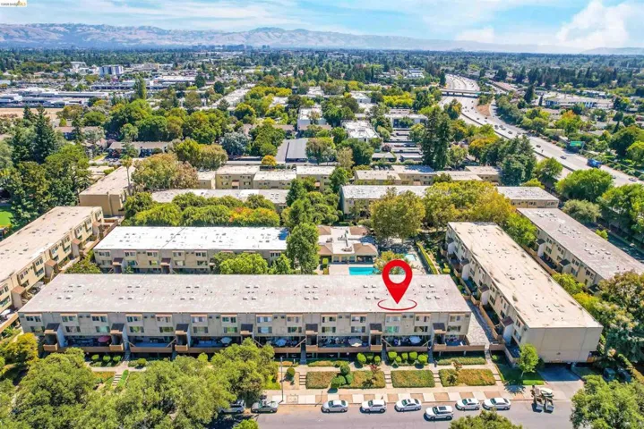 Bird's eye view of apartment complex / building and a mountainous background