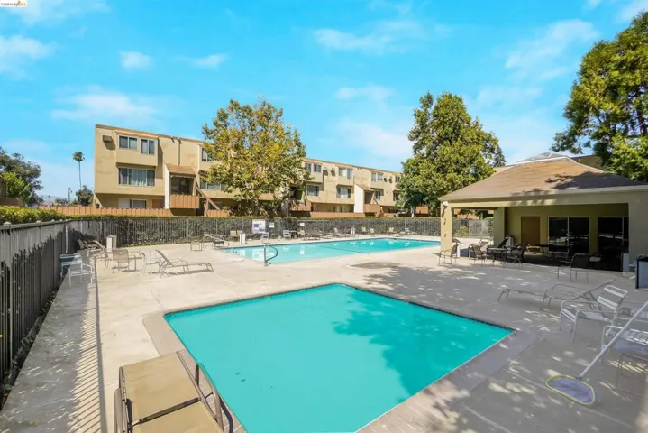 Community pool with a patio