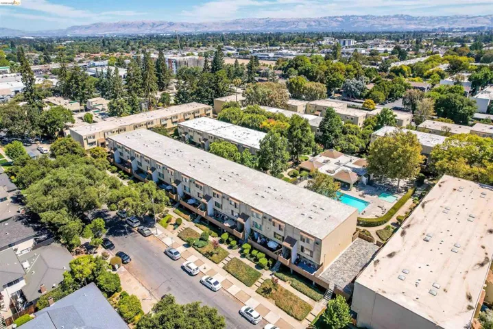 View of property location with apartment complex and mountains