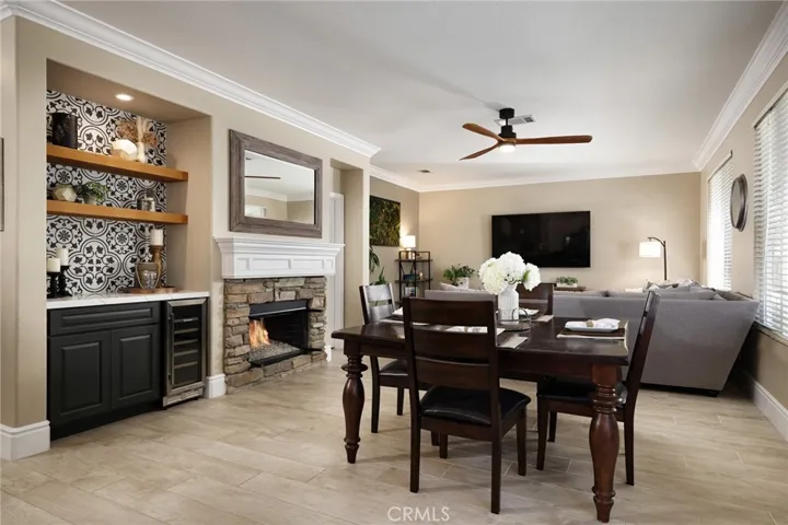 Adjacent to the kitchen is the family room and dining area are centered around a stacked stone fireplace.