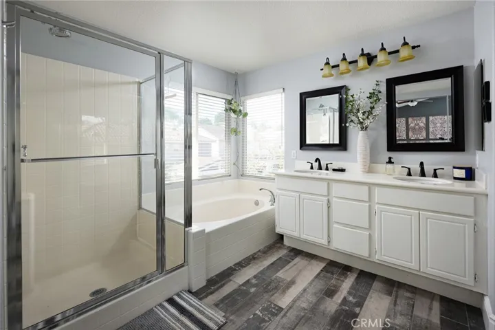 There is a soaking tub, separate stall shower in the primary bathroom.