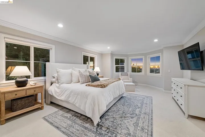 Bedroom with light carpet, recessed lighting, and crown molding