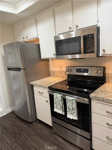 New stainless-steel refrigerator included. Newer electric range and microwave