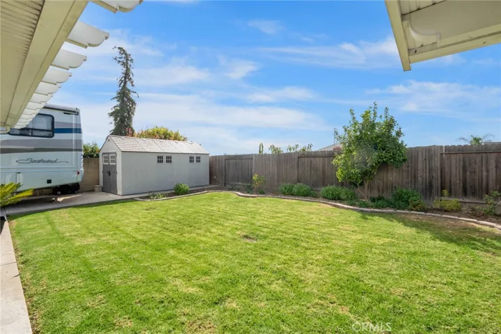 Large yard with new plants and mature fruit trees