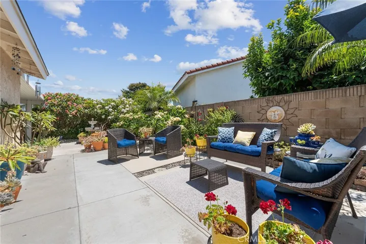 Side backyard surrounded by desert scape and plumerias