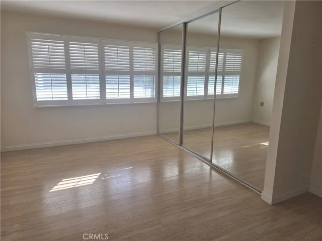 Primary bedroom with mirrored wardrobe.