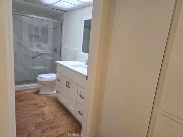 Guest bathroom under a skylight showing entry area linen closet