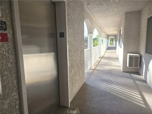 Elevator to breeze way, southern exposure, to get to the Unit C, photo was taken after 3 pm.