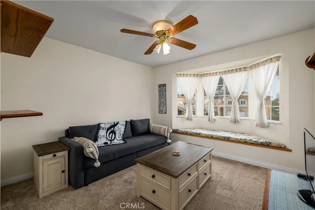 Bedroom with window seat and a walk in closet upstairs.