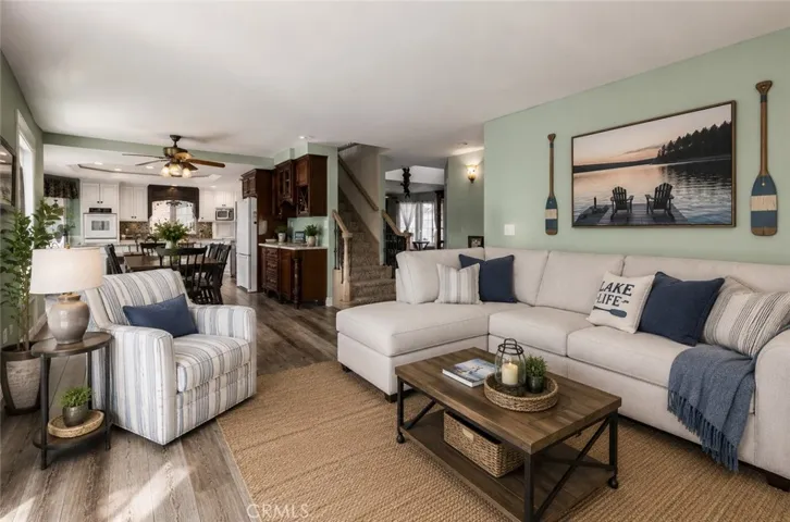 The family room is open and their are beautiful views from the window. Please note, AI updated furniture.