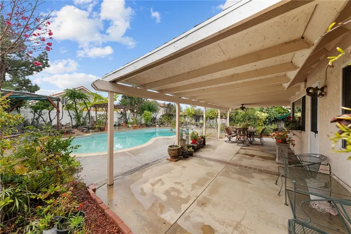 Expanded patio view featuring outdoor dining/lounge space with easy access to the pool.