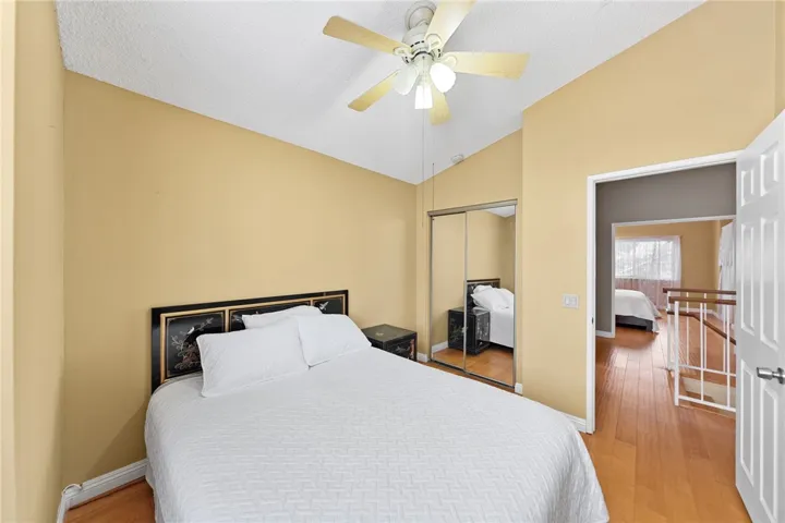 Another view highlighting the mirrored closet doors and flow to the upstairs landing.