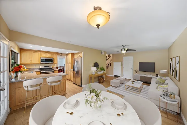Artificial rendering: Bright, flexible layout connecting kitchen, dining, and living spaces with a breakfast bar for casual seating.