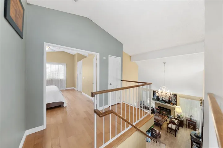 Bright hallway with open sightlines to the living area below and access to adjacent rooms.