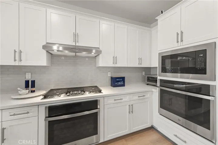 5 burner gas cooktop, vented hood and double oven