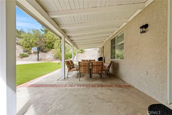 Covered patio with turf backyard