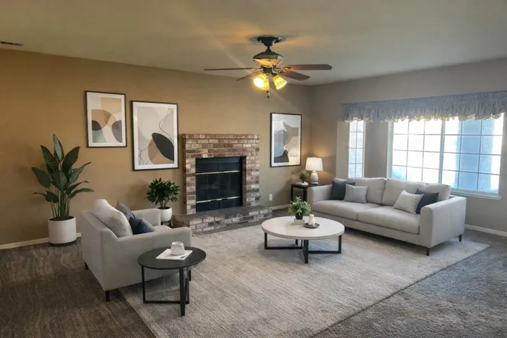 Living area featuring a fireplace and a ceiling fan