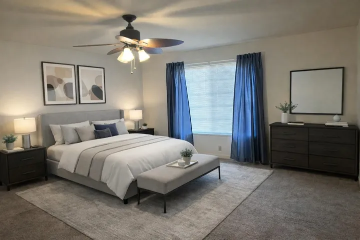 Carpeted bedroom featuring ceiling fan