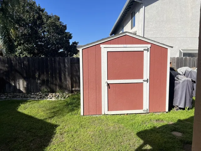 View of shed featuring a fenced backyard