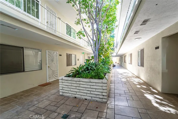 Interior Courtyard with Trees Reaching Up to the Top Floor