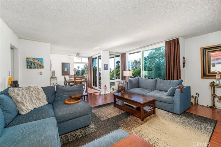 Living Room & Dining Room with Floor to Ceiling Sliders and Windows