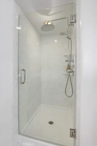 This shower is in primary by dual vanity sinks