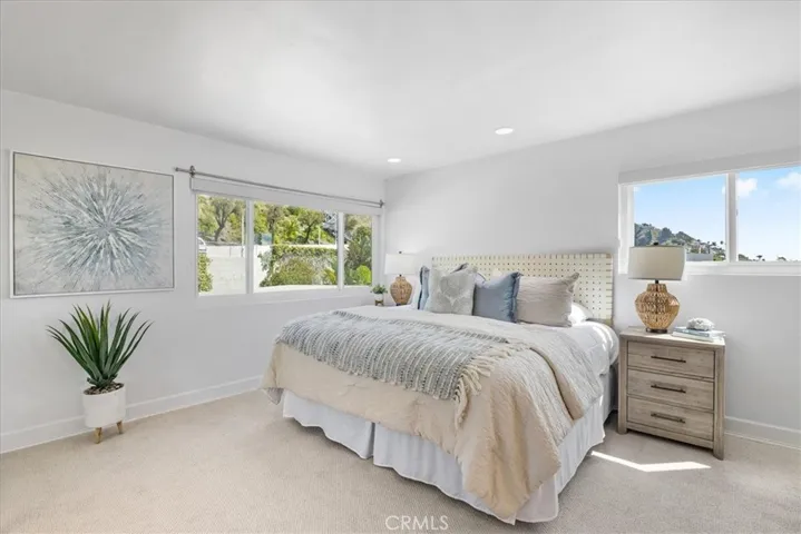 Tranquil primary bedroom with amazing ocean and hills views facing south