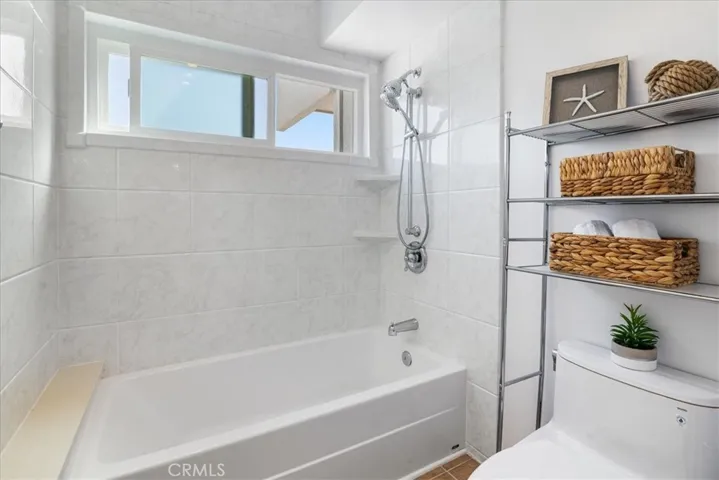 Ocean view primary bathroom with dual showers (one outside of water closet/shower/bath too)