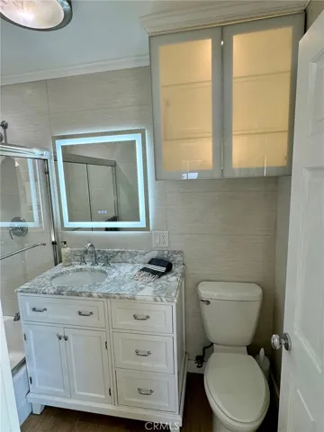 Highly upgraded bathroom with ample storage, lit vanity mirror & mirrored medicine cabinet