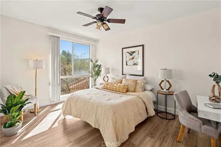 Bedroom with new flooring, ceiling fan, loads of natural light and lots of room