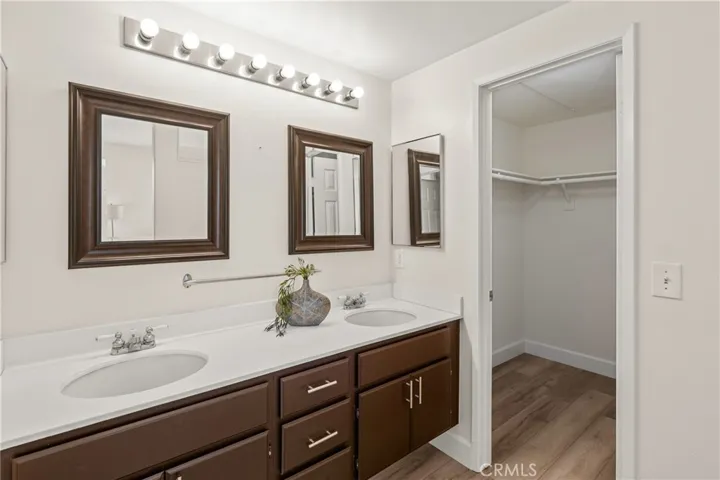 En Suite bathroom with dual sinks, and huge walk-in closet