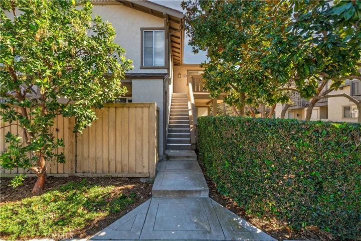 Stairs to upper level condo, with ground level storage closet