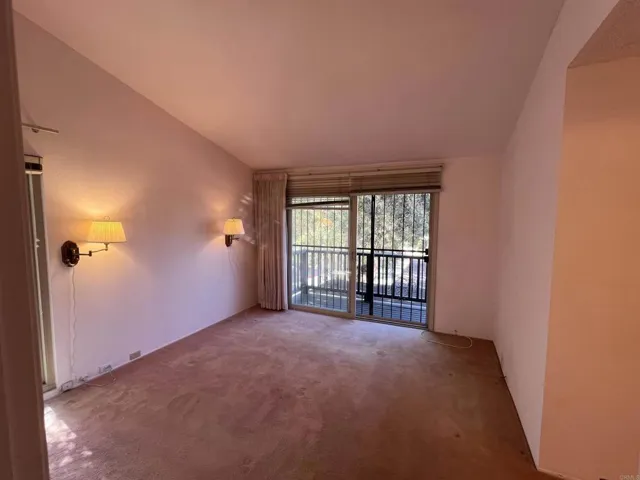 Large primary bedroom with a private deck; end-unit windows bring in abundant natural light.