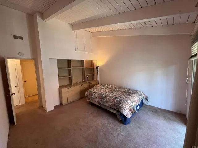 Spacious upstairs bedroom with vaulted ceilings and its own deck.