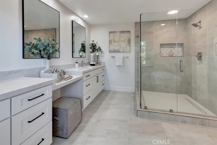 spa-inspired bath complete with oversized walk-in shower, freestanding soaking tub, dual quartz vanities, and three generous walk-in closets.